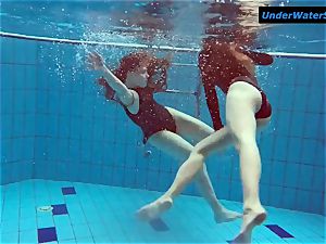 two steaming teenagers underwater