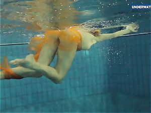 Yellow and red dressed teenager underwater